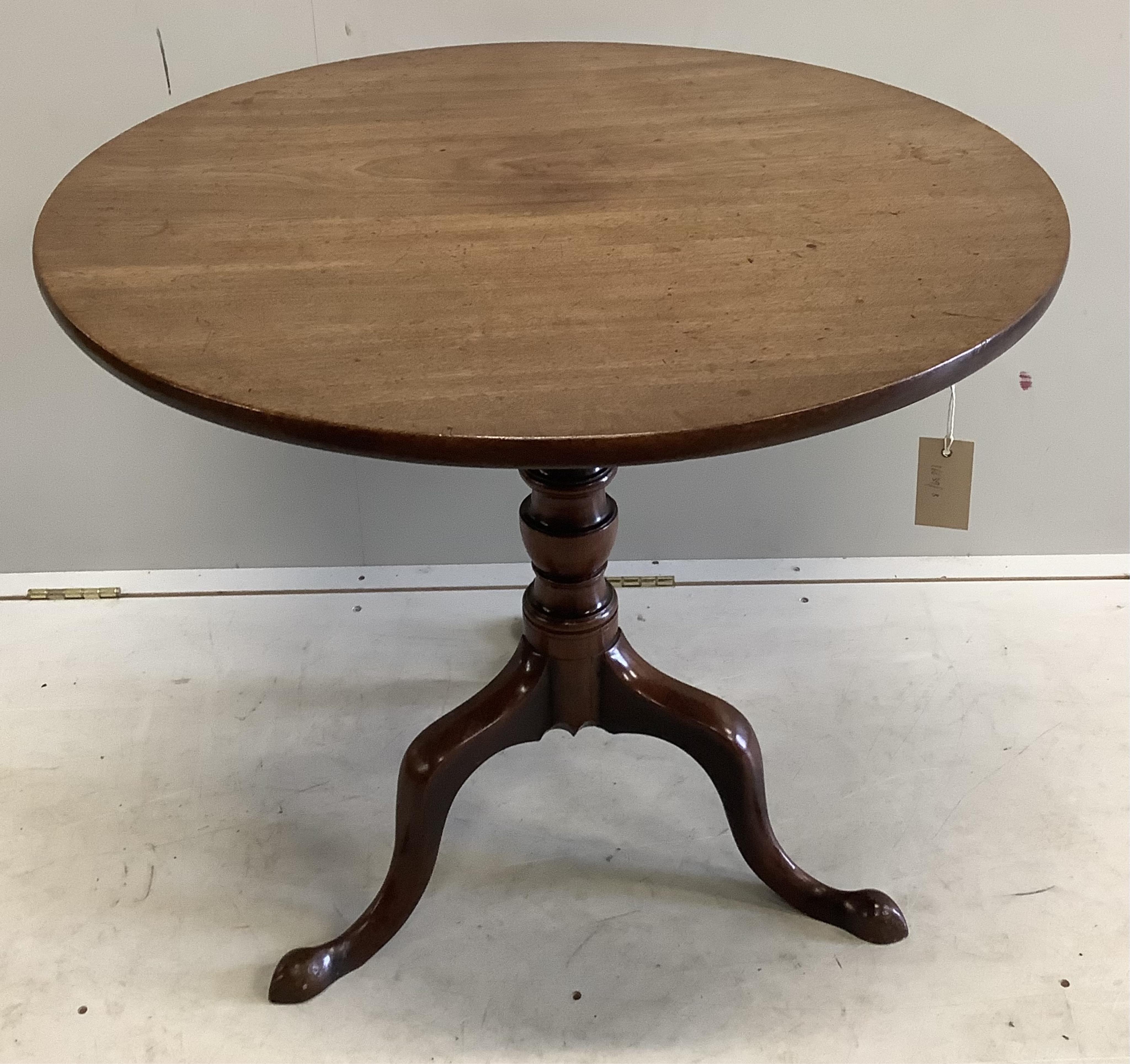 A George III circular mahogany tilt top tripod tea table, diameter 79cm, height 70cm. Condition - fair to good
